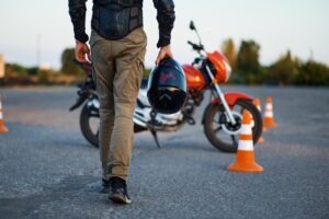 Person holds helmet. Does motorcycle insurance cover medical bills?